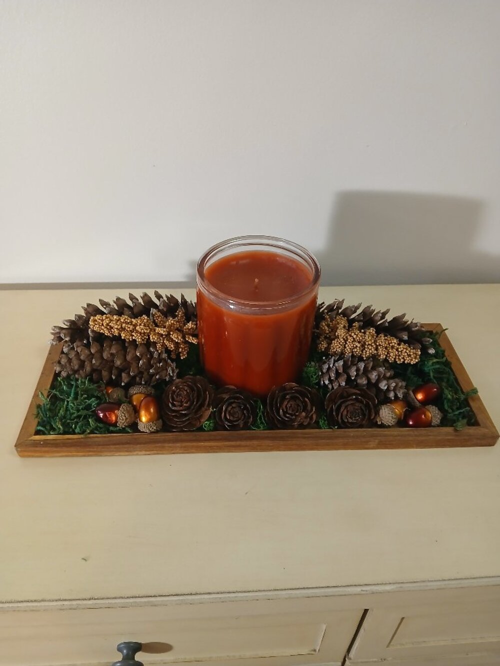 Wooden tray with new candle and nature decor